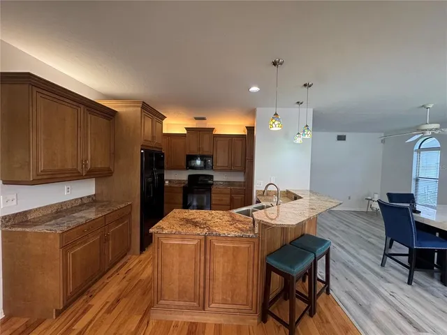 a large kitchen with a table and chairs in it