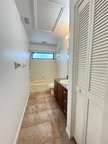 a spacious bathroom with a granite countertop sink a mirror and vanity