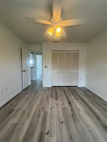 a view of a room with wooden floor