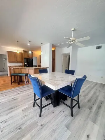 a view of a dining room with furniture wooden floor and chandelier