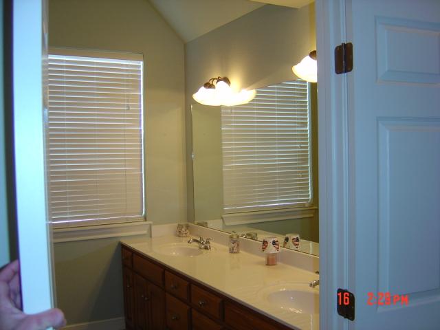 8701 Blackhawk Road Amarillo, TX 79119 - Photo 10 of 20 a bathroom with a sink and a mirror