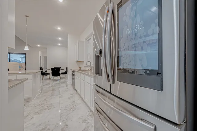 a kitchen with stainless steel appliances kitchen island granite countertop a sink and cabinets