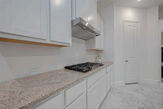 a kitchen with stainless steel appliances granite countertop a sink and a refrigerator