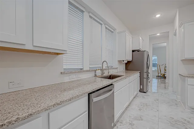 a kitchen with stainless steel appliances granite countertop a stove microwave and refrigerator