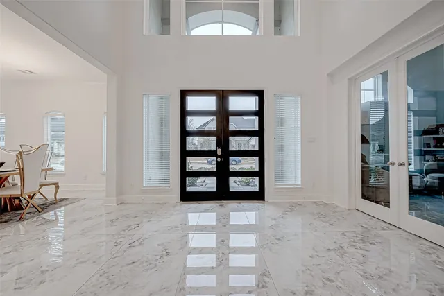 a view of staircase with lots of frames on wall and wooden floor