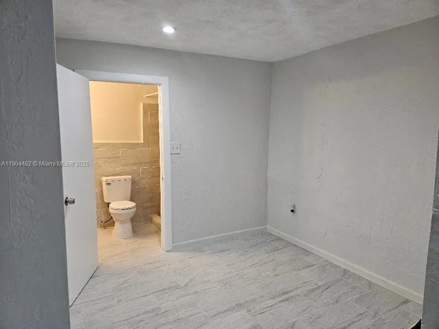 a view of bathroom with a toilet and a shower