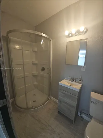 a bathroom with a mirror toilet and a shower