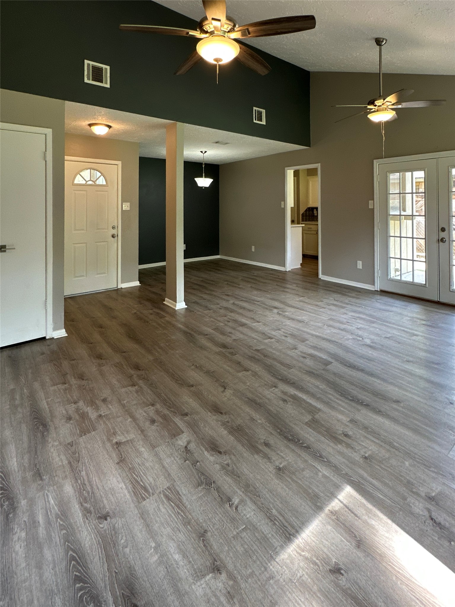26403 Hunters Hollow Drive Spring, TX 77380 - Photo 2 of 34 View of entryway, dining room, kitchen, and living room with vaulted ceiling!