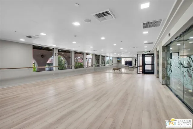 a dining room with furniture and wooden floor