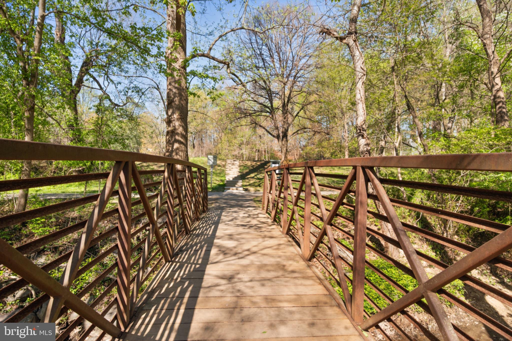1001 Robin Road Silver Spring, MD 20901 - Photo 42 of 46 Serene bridge through lush greenery.