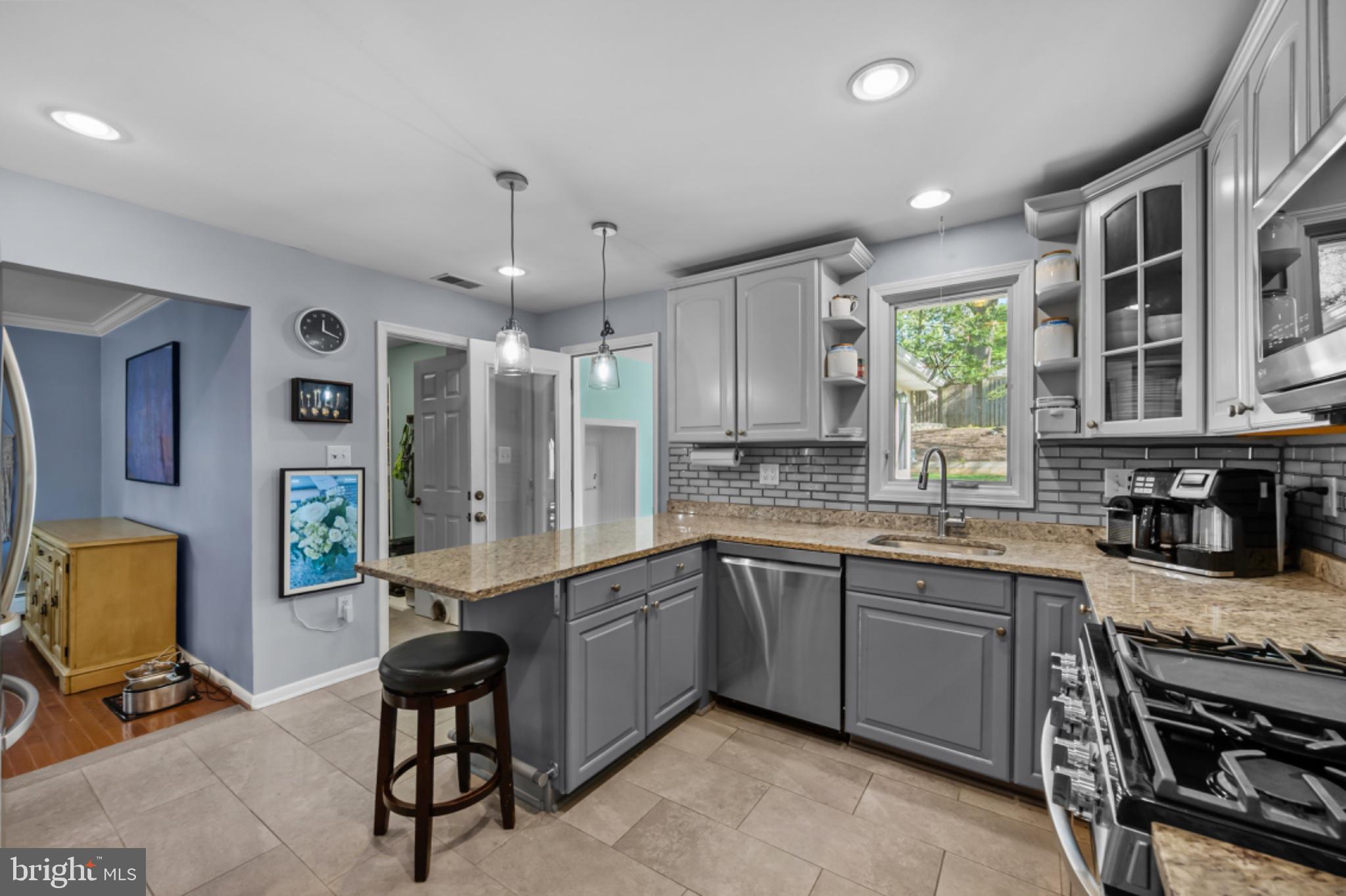 1001 Robin Road Silver Spring, MD 20901 - Photo 9 of 46 Modern kitchen with sleek finishes.