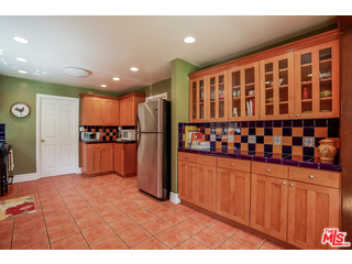 1555 Campus Road Los Angeles, CA 90042 - Photo 16 of 35 a kitchen with stainless steel appliances kitchen island granite countertop a refrigerator and a sink