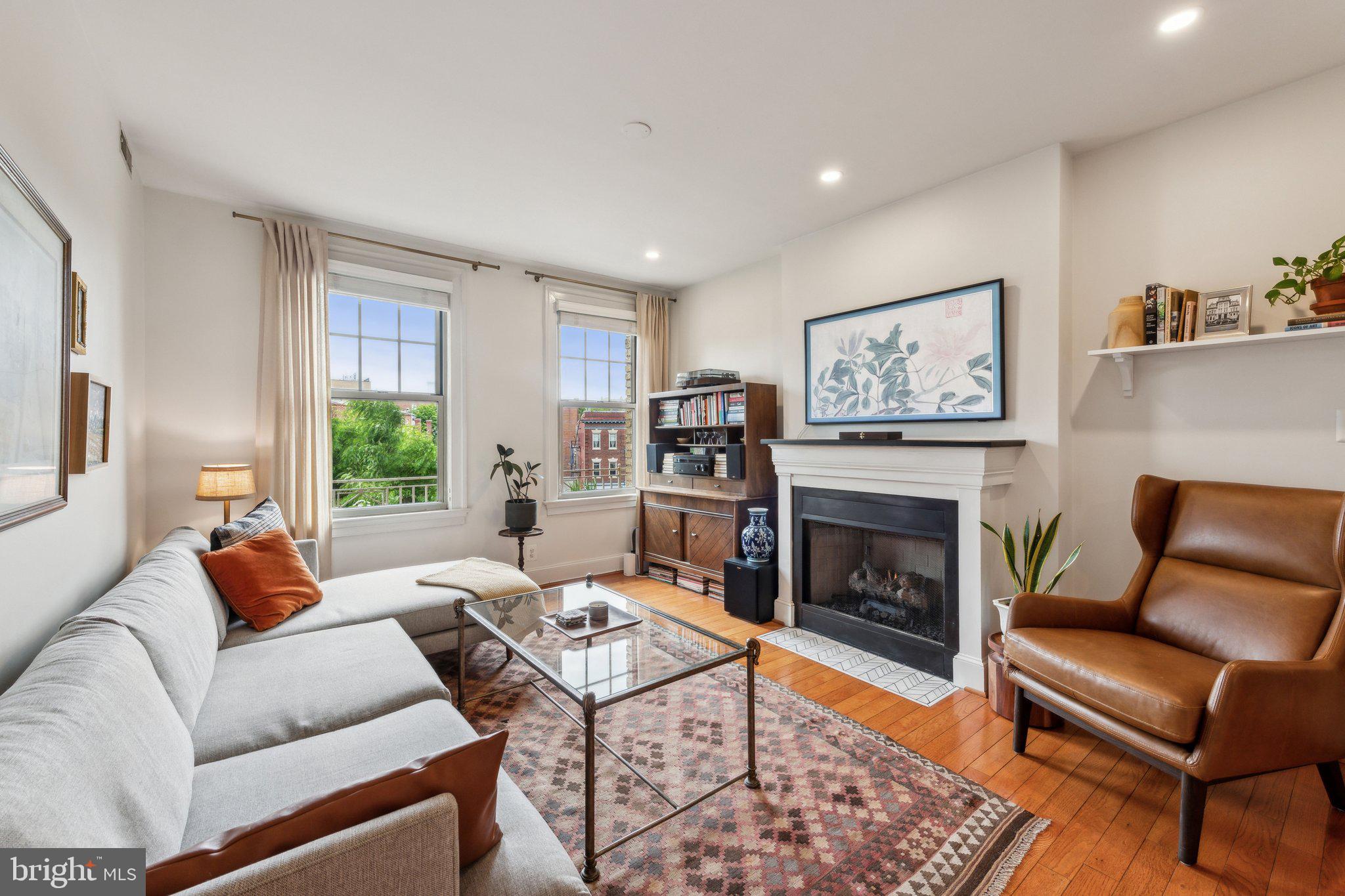 a living room with furniture a rug and a fireplace