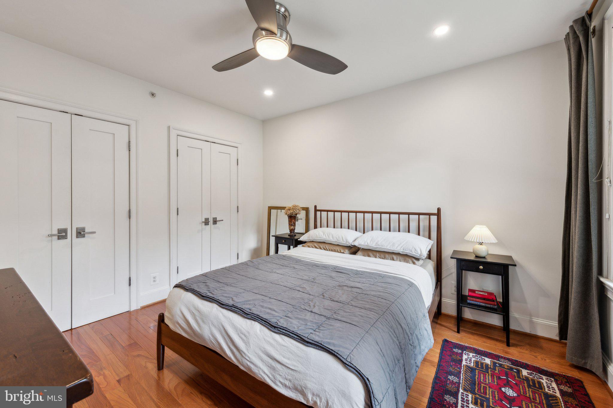 3220 17th Street Northwest, Unit 309 Washington, DC 20010 - Photo 14 of 25 a bedroom with a large bed and a chandelier