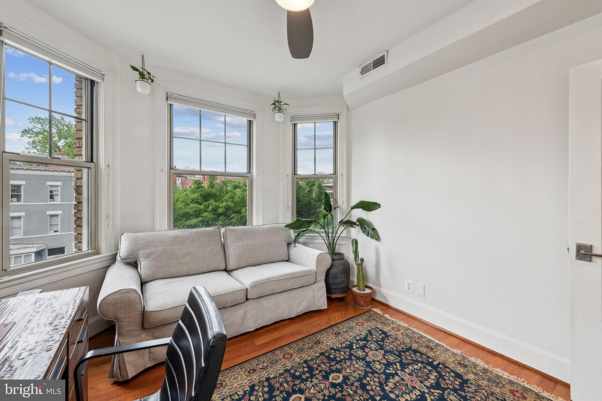 3220 17th Street Northwest, Unit 309 Washington, DC 20010 - Photo 15 of 25 a living room with furniture and a window