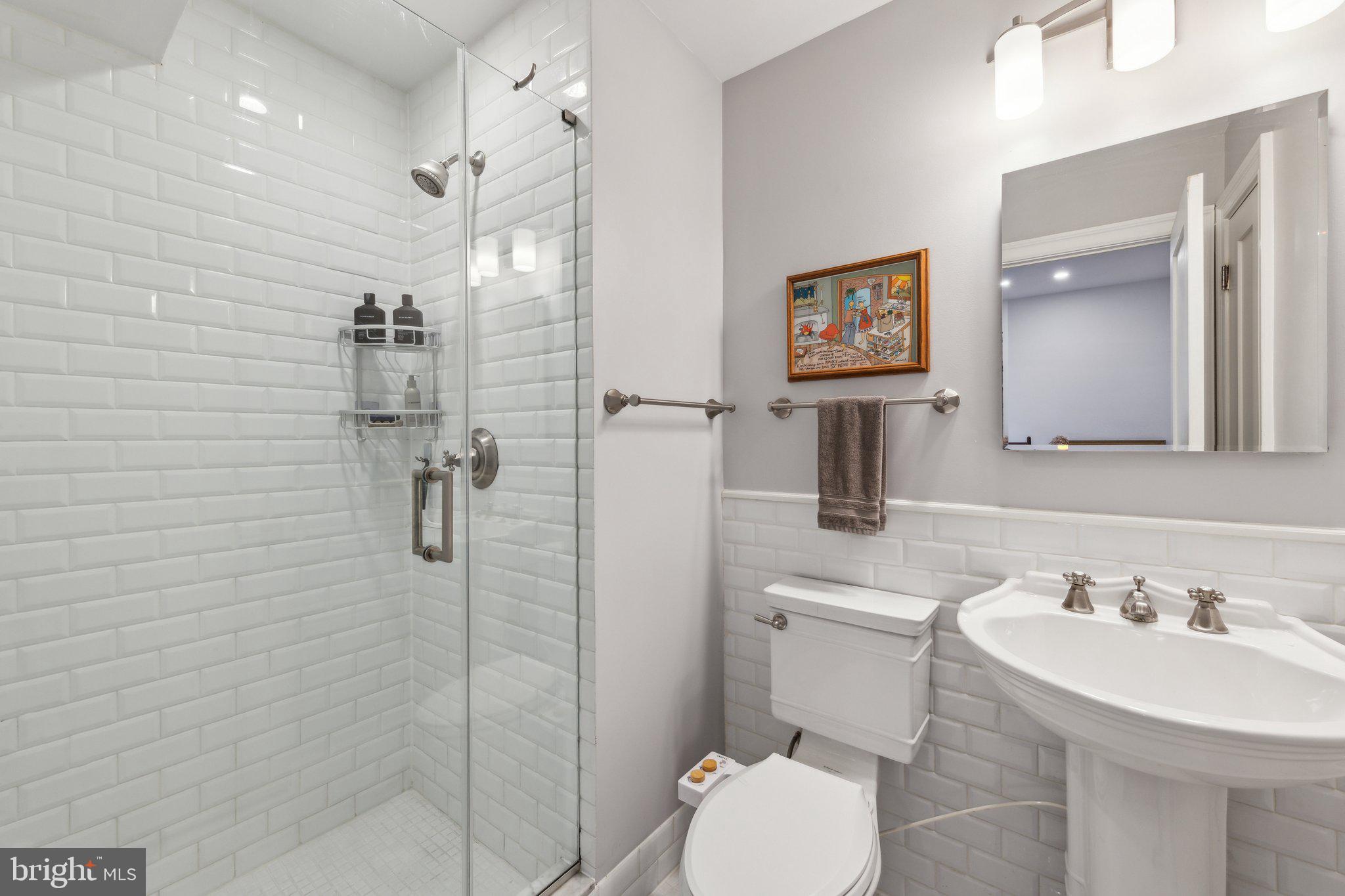 3220 17th Street Northwest, Unit 309 Washington, DC 20010 - Photo 16 of 25 a bathroom with a sink toilet and shower