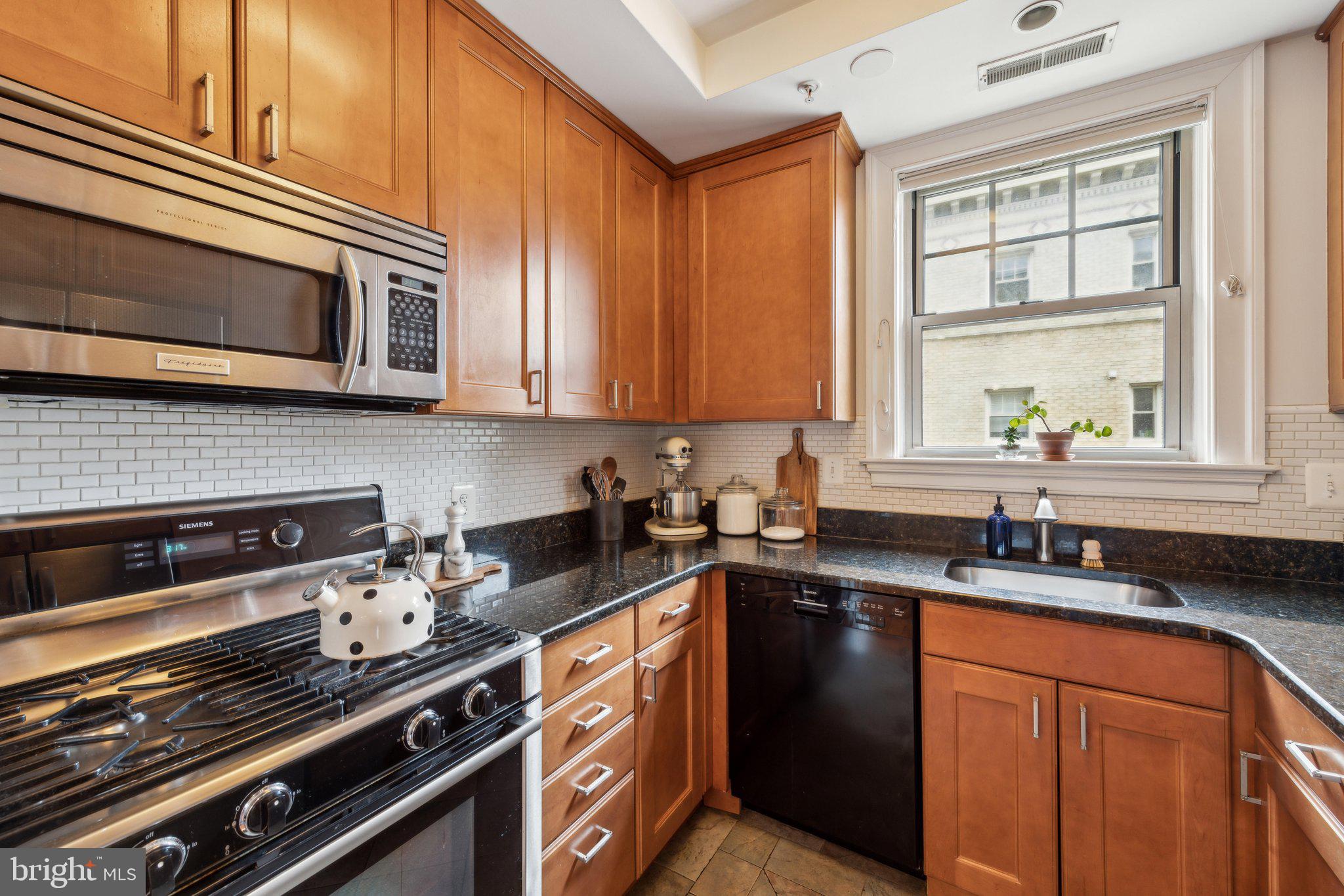 3220 17th Street Northwest, Unit 309 Washington, DC 20010 - Photo 2 of 25 a kitchen with stainless steel appliances a sink stove and cabinets