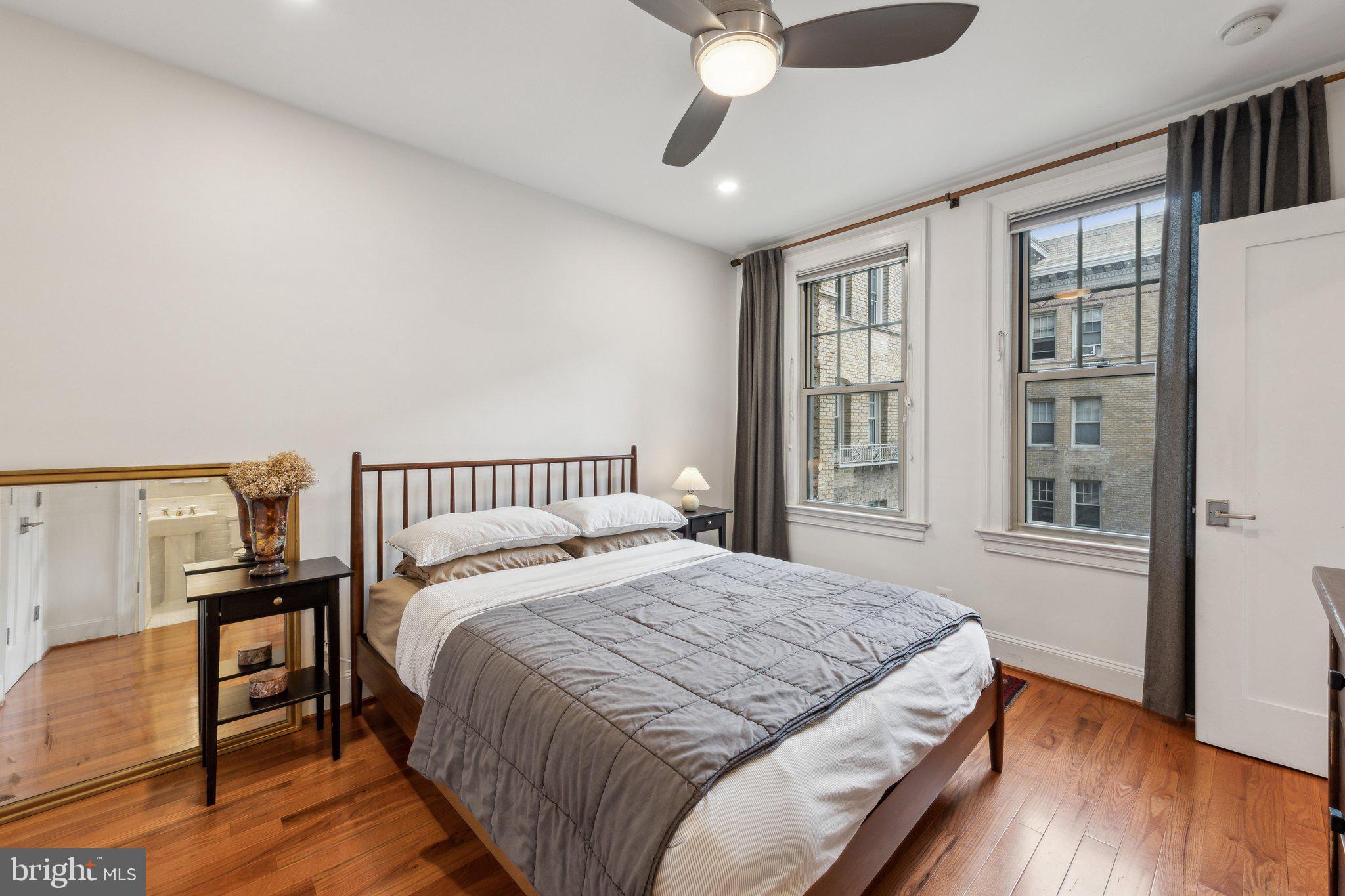 3220 17th Street Northwest, Unit 309 Washington, DC 20010 - Photo 4 of 25 a bedroom with a bed and wooden floor