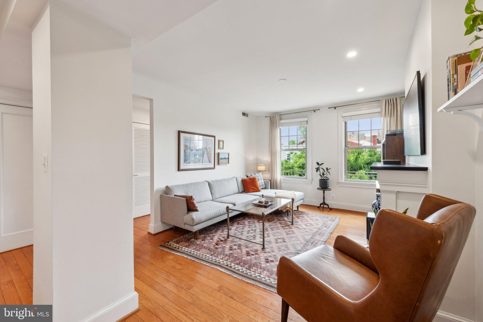 3220 17th Street Northwest, Unit 309 Washington, DC 20010 - Photo 7 of 25 a living room with furniture and a large window