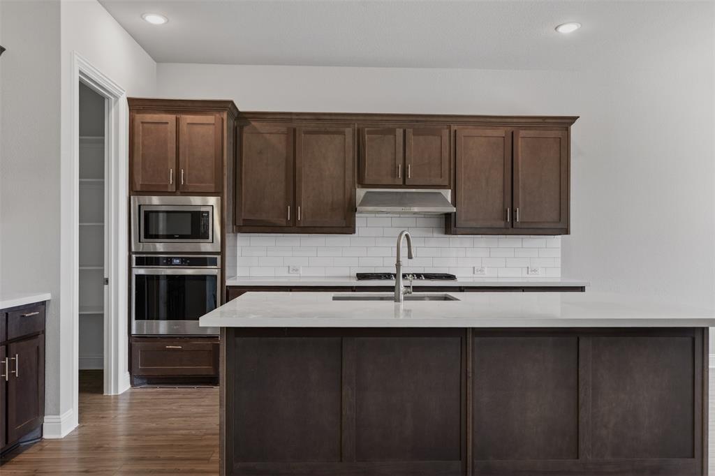 16812 Bitterroot Road Justin, TX 76247 - Photo 16 of 27 a kitchen with a refrigerator and a sink