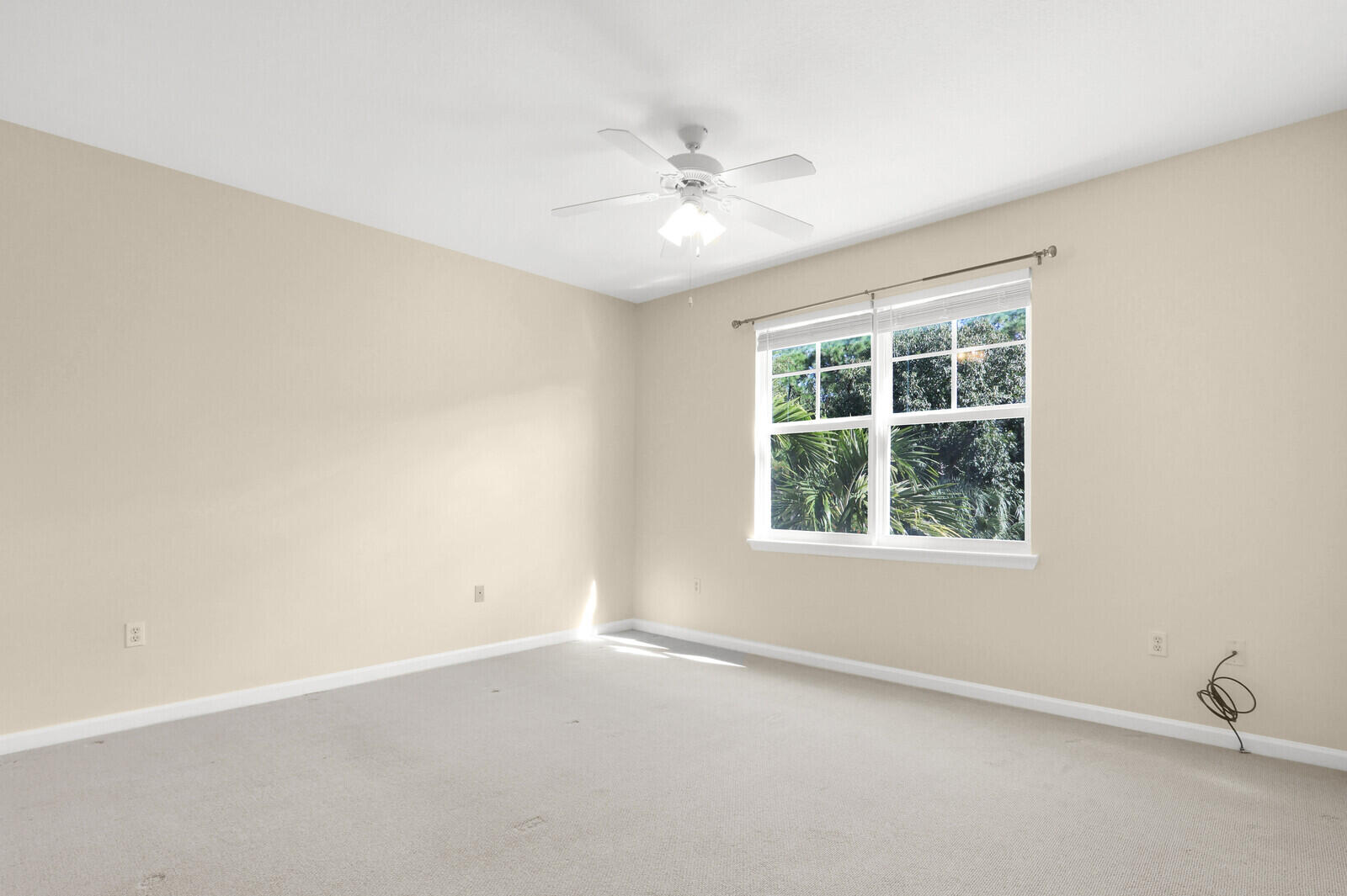 255 Murcia Drive, Unit 202 Jupiter, FL 33458 - Photo 16 of 63 an empty room with a window and a fan