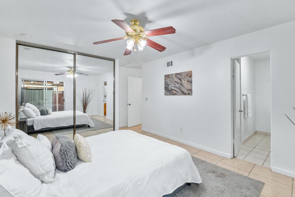 514 Shady Lane, Unit C El Cajon, CA 92021 - Photo 19 of 30 a bedroom with a large bed and a chandelier