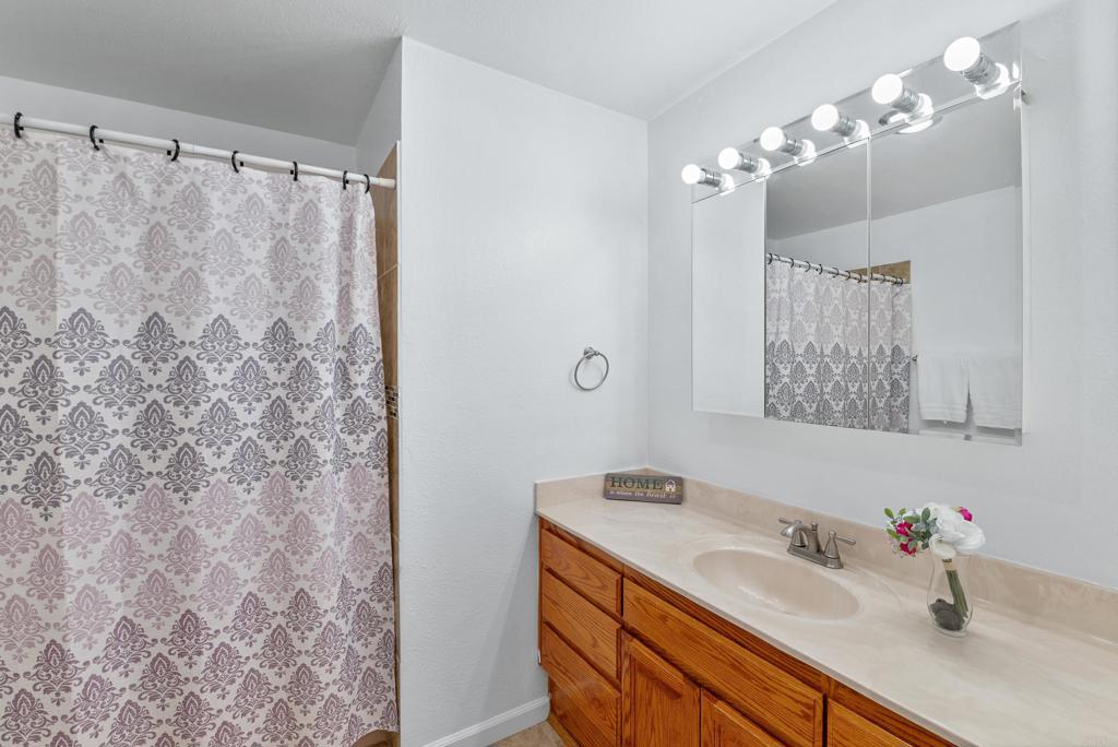 514 Shady Lane, Unit C El Cajon, CA 92021 - Photo 23 of 30 a bathroom with a sink vanity granite and a mirror