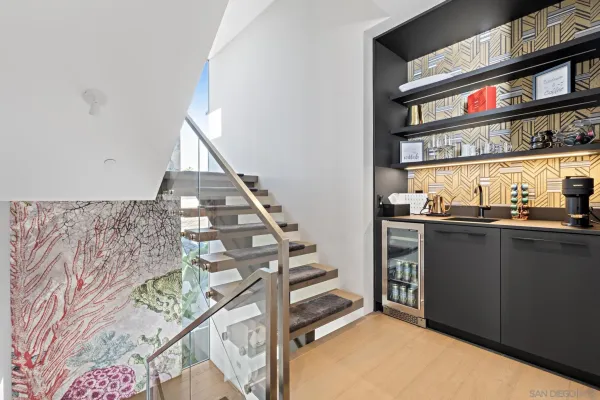 a kitchen with a refrigerator and white cabinets