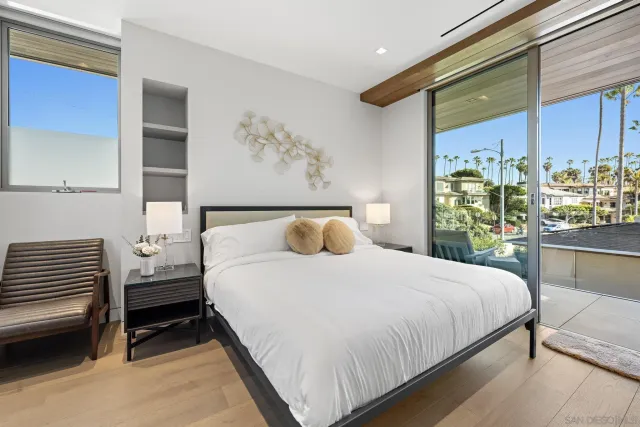 a bedroom with a large bed and a chandelier