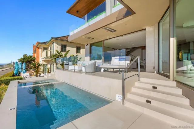 a view of living room kitchen with stainless steel appliances cabinets