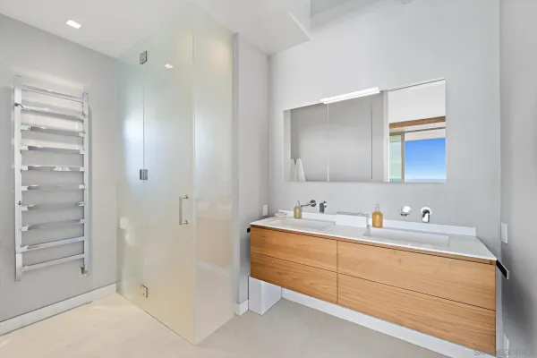 a bathroom with a double vanity sink a mirror and a shower