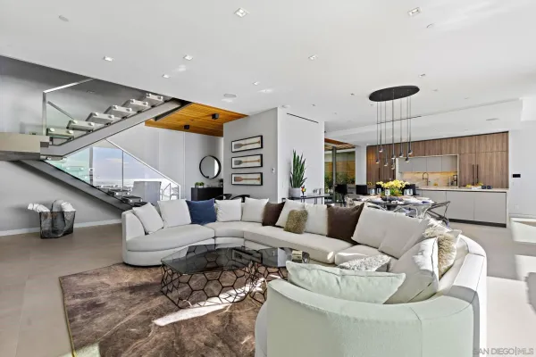 a living room with furniture and a chandelier