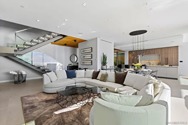 a living room with furniture and a chandelier