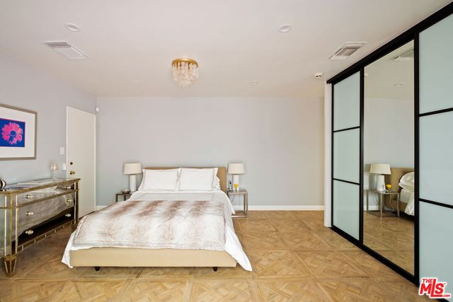 a bedroom with a bed and dresser with window