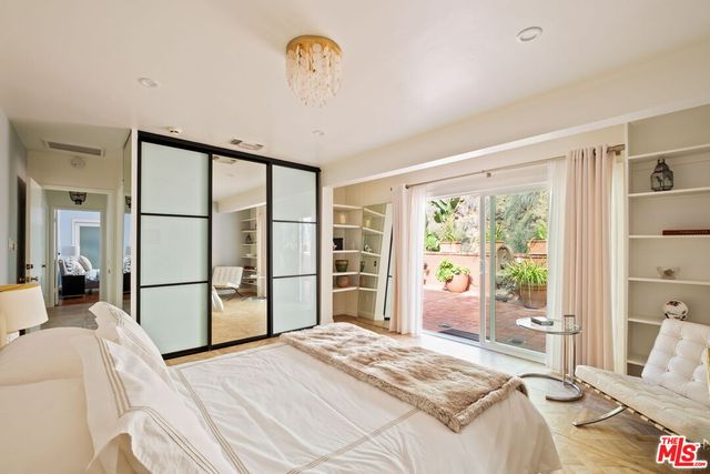 a bedroom with a bed and a large window