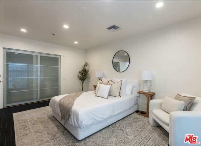 a bedroom with bed and a window