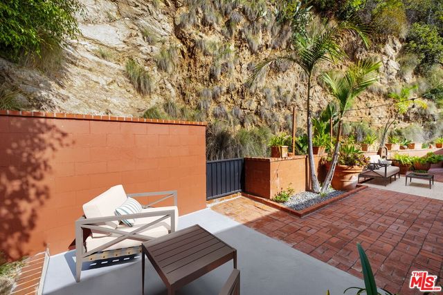 an outdoor space with lounge chair