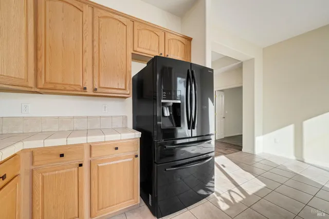 a kitchen with metallic refrigerator freezer and a dishwasher