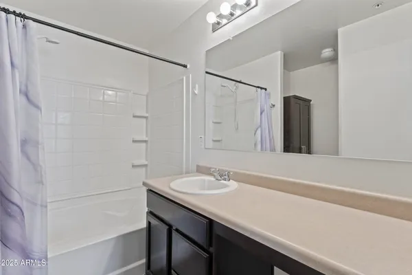 a bedroom with a large bed and a mirror