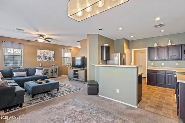 a living room with furniture and a potted plant