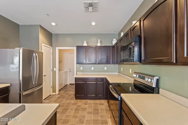 a living room with furniture and a kitchen