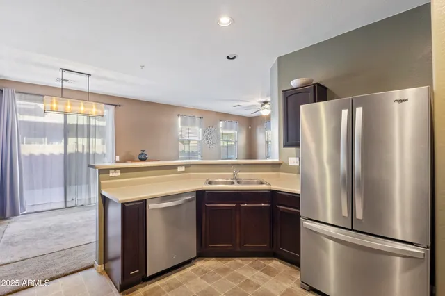 a kitchen that has a sink and a stove in it