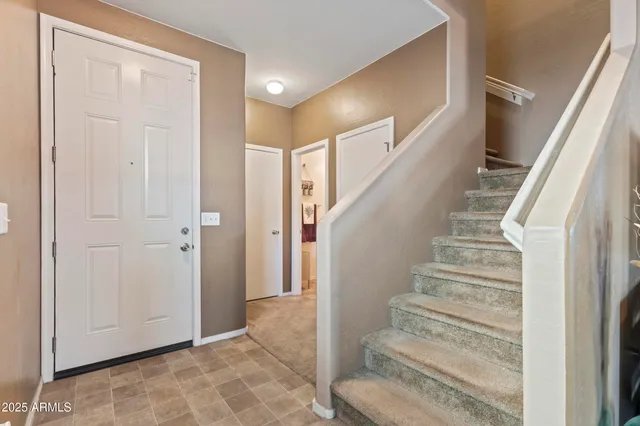 a view of a hallway to a livingroom with furniture