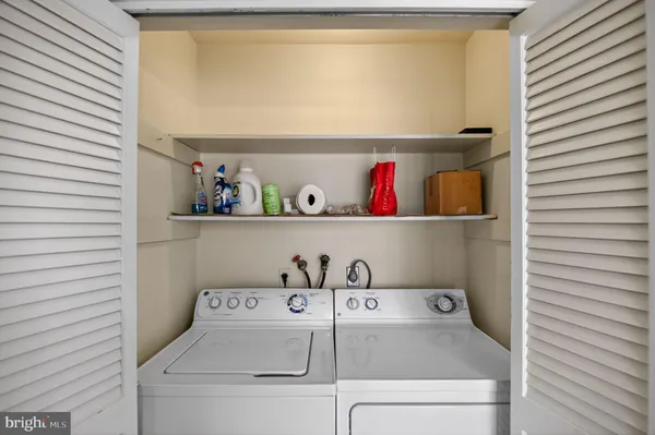 a view of utility room with two washing machine