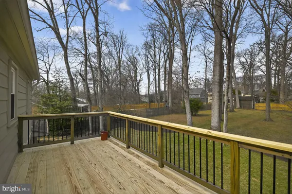 a view of balcony with wooden floor and fence