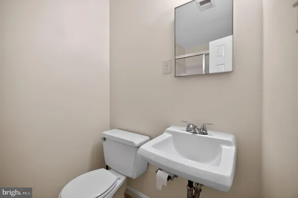 a white toilet sitting next to a bathroom sink