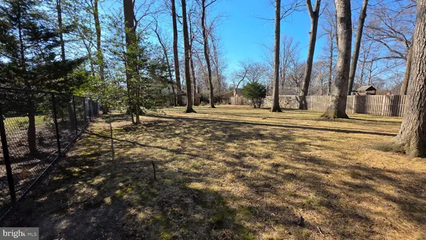a view of a large white building with trees in front of it