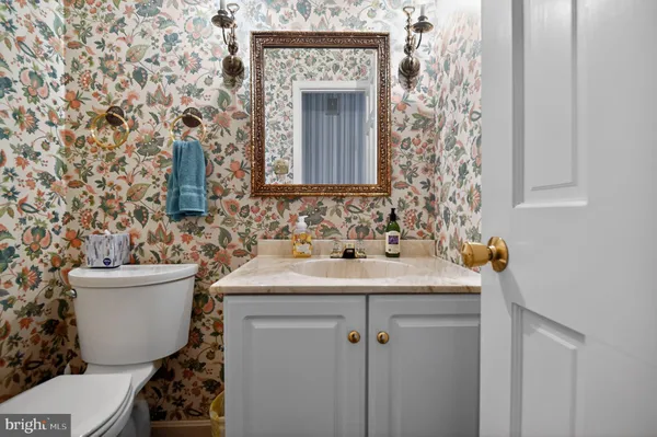 a bathroom with a sink toilet and mirror