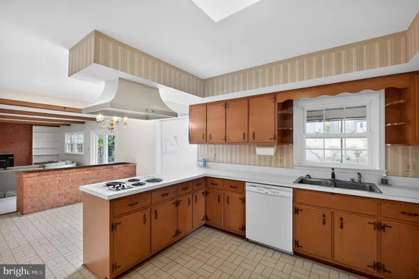 a kitchen with stainless steel appliances granite countertop a sink and cabinets
