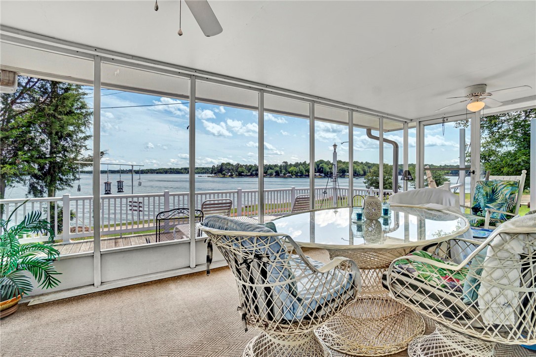 Panoramic lake views from this sun-filled screened porch, perfect for relaxation.